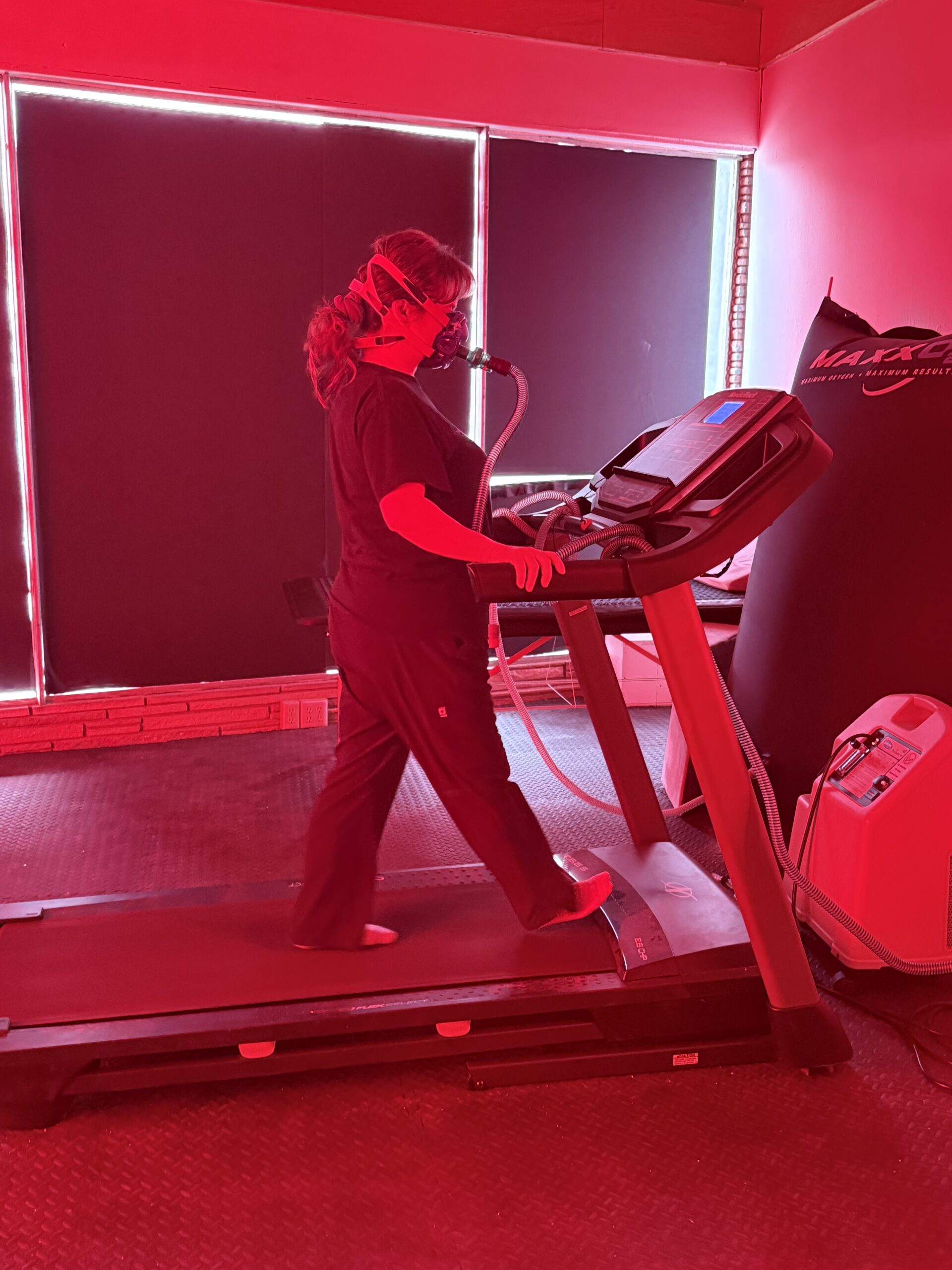 woman walking on treadmill while breathing concentrated oxygen